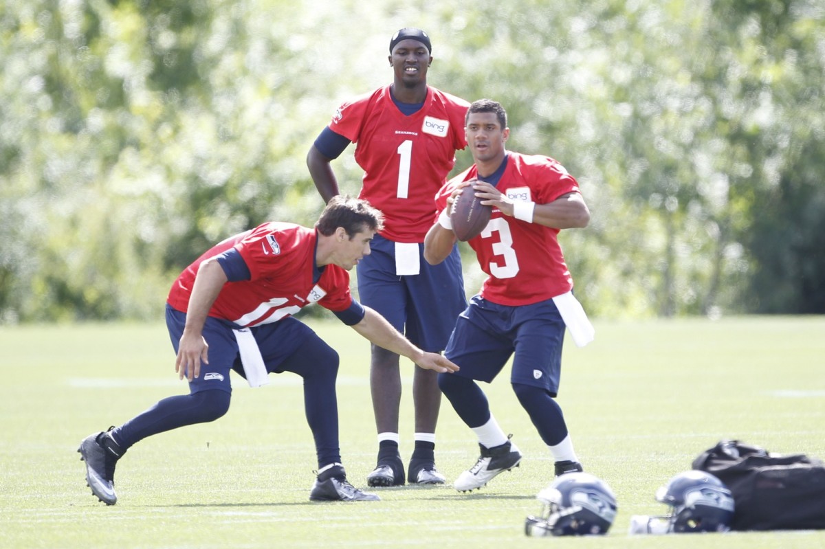 Jun 12, 2013; Renton, WA, USA; Seattle Seahawks quarterback Russell Wilson (3) and quarterback Brady Quinn (10) do a drill following minicamp practice at the Virginia Mason Athletic Center. Seattle Seahawks quarterback Jerrod Johnson (1) stands behind Wilson and Quinn.